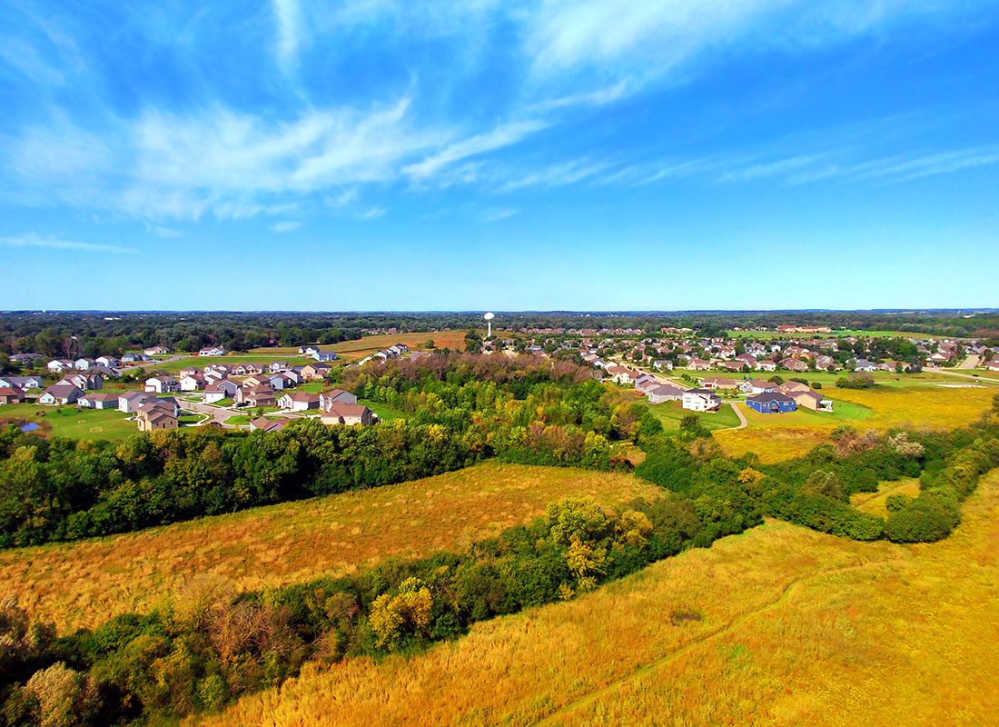 Freedom, WI - Aerial View of the Small Town of Freedom Wisconsin Surrounded by Colorful Trees and Open Fields of Grass in the Early Autumn on a Sunny Day