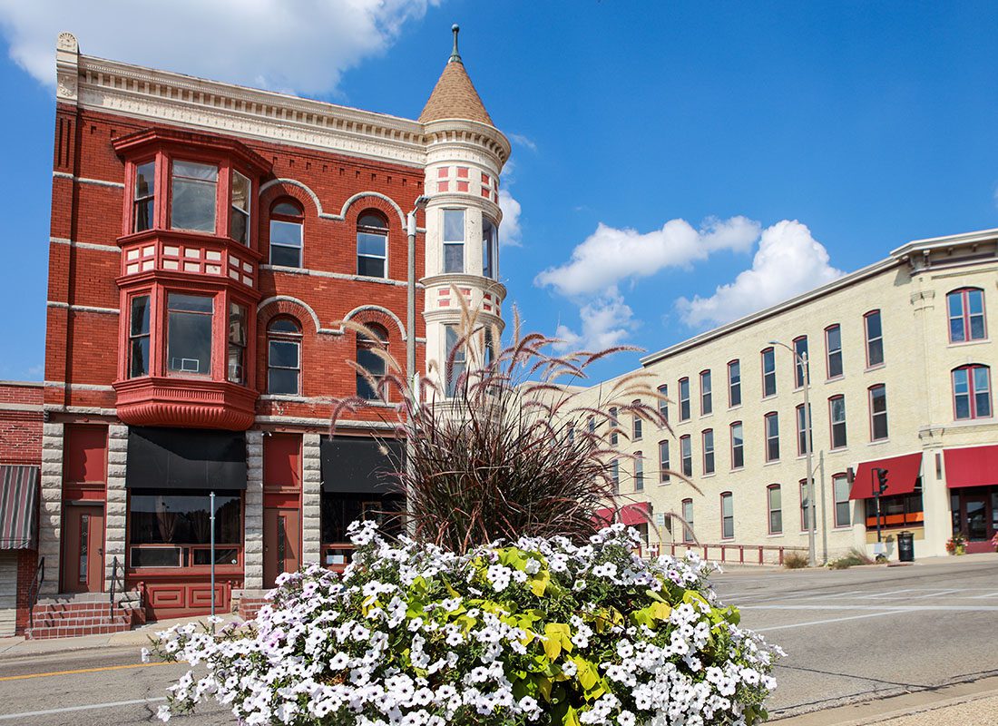 Seymour, WI - View of Downtown Main Street Old Historical Brick Buildings in Seymour Wisconsin with Decorative Flowers Across the Street